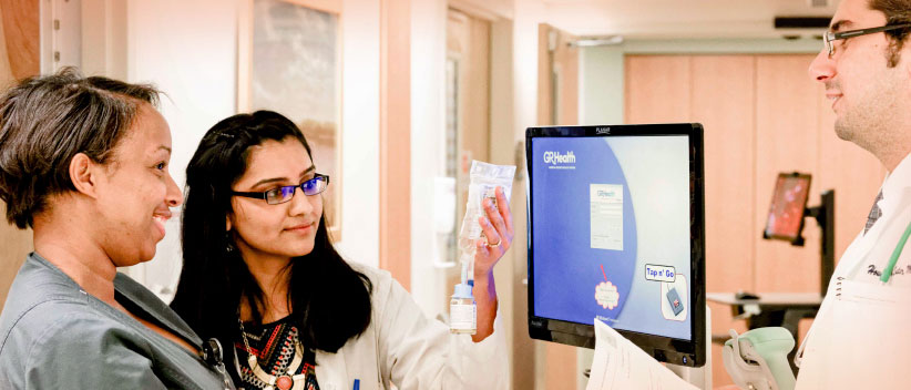 About HOPA image of three pharmacists looking at medical drip bag by computer