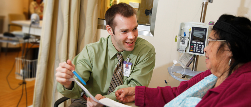 HOPA Membership image of young man explaining paperwork to a woman